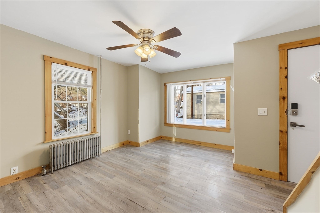 36 Sullivan Avenue Hardwick, MA 01031 - Photo 6 of 42 a view of an empty room with a window and wooden floor