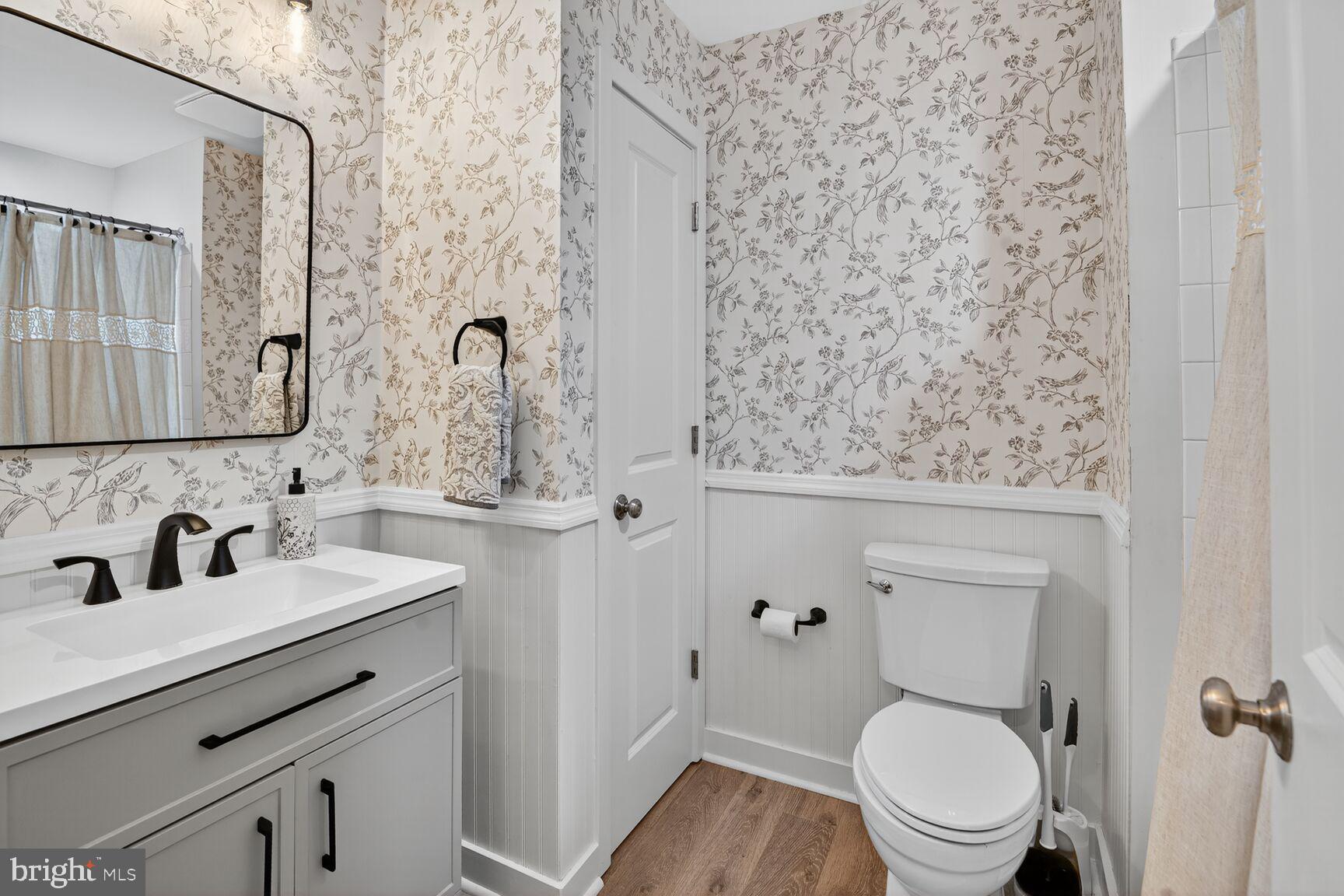 1449 Trafalgar Lane Frederick, MD 21701 - Photo 15 of 28 a bathroom with a toilet sink and mirror