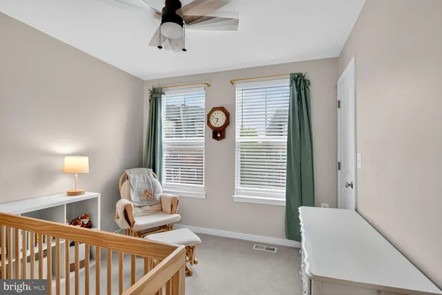 a bedroom with furniture and a book shelf