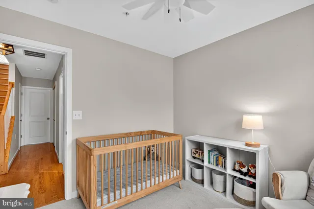 a view of a hallway with wooden floor and entryway