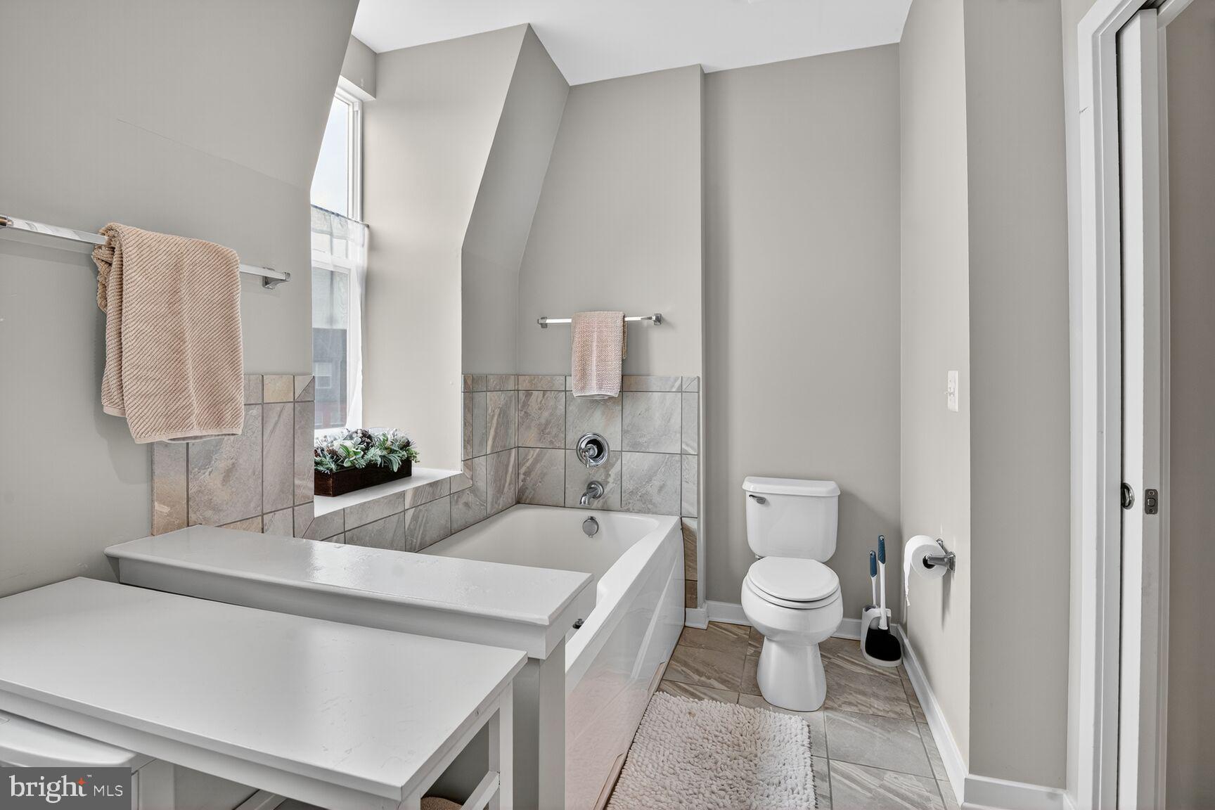 1449 Trafalgar Lane Frederick, MD 21701 - Photo 26 of 28 a spacious bathroom with a sink a toilet and shower curtain