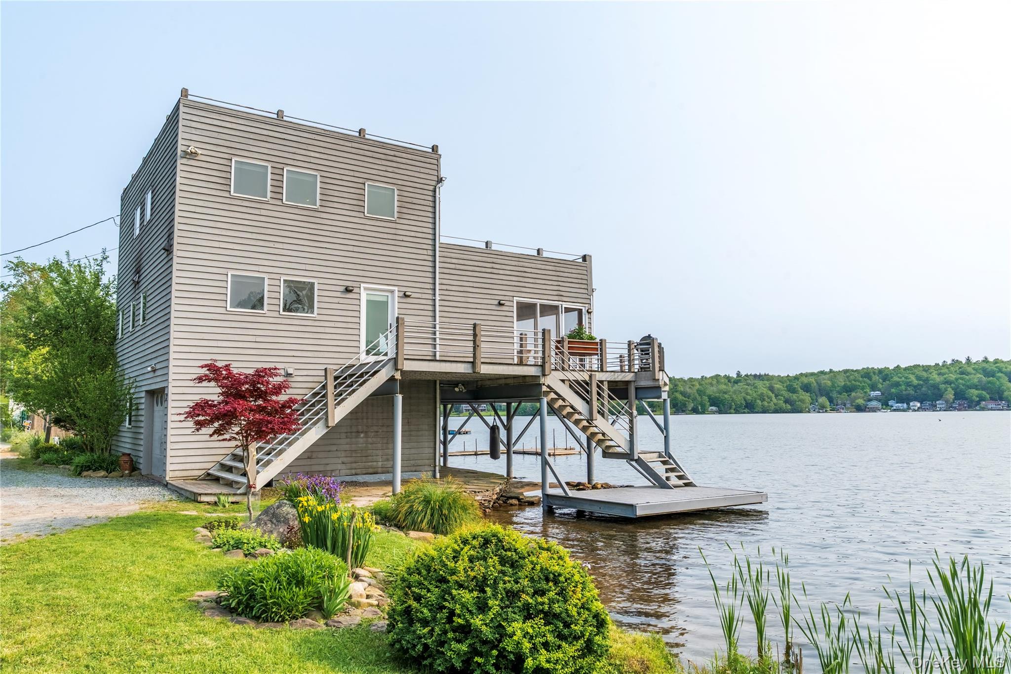 13 West Shore Road Kauneonga Lake, NY 12749 - Photo 1 of 16 a view of a house with a yard and potted plants
