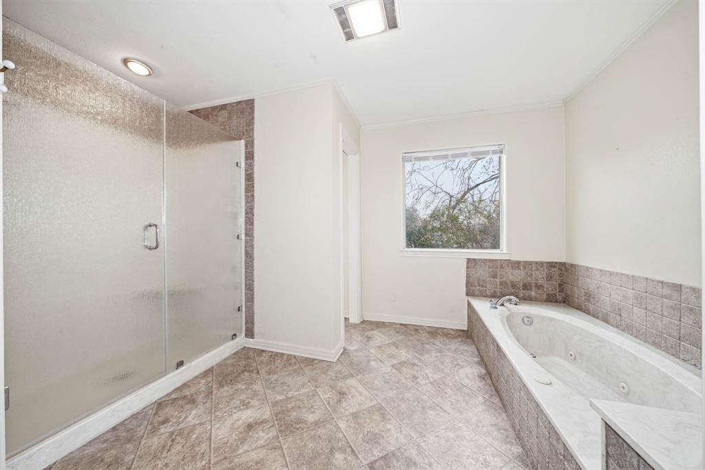 3400 Timbermill Road Waco, TX 76710 - Photo 13 of 35 a bathroom with a bathtub and a shower