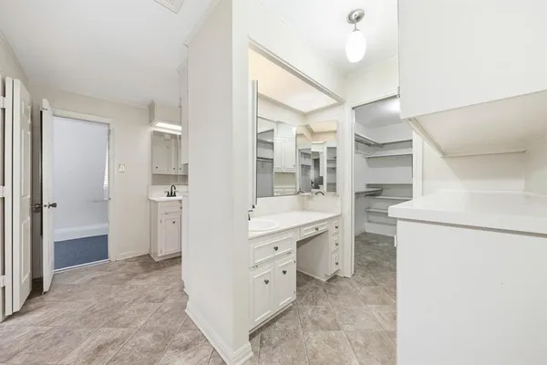 a bathroom with a granite countertop sink mirror and a shower