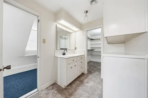 a bathroom with a sink a mirror and a vanity