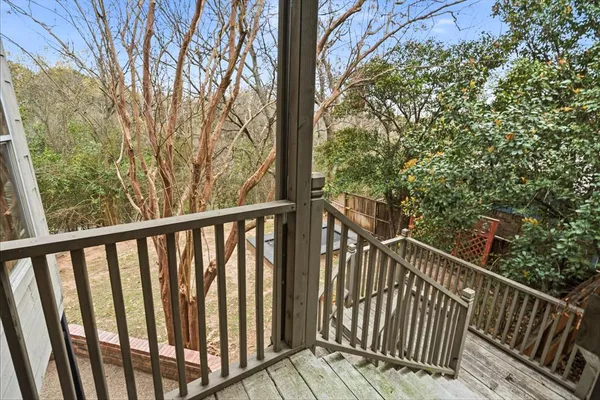 a view of a balcony with wooden floor and fence