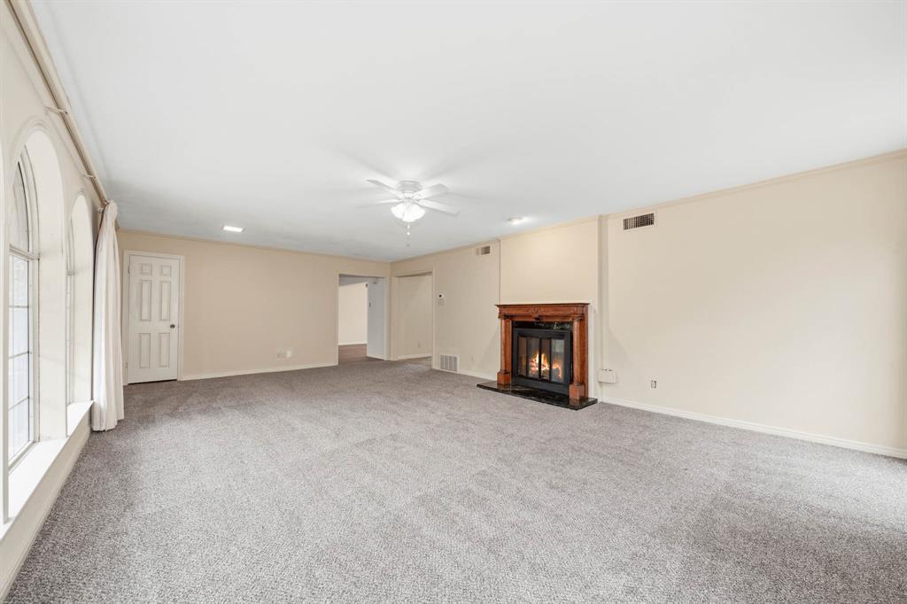 3400 Timbermill Road Waco, TX 76710 - Photo 5 of 35 an empty room with fireplace and windows
