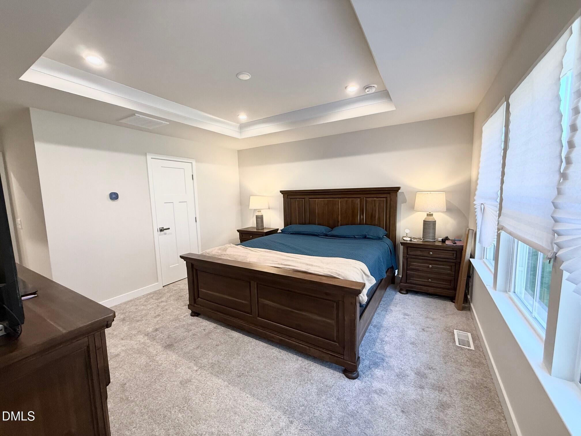 1362 Chowan Avenue Durham, NC 27713 - Photo 13 of 27 a bedroom with a bed and a flat tv screen on a dresser