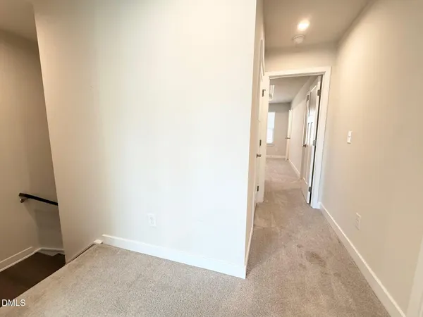 an empty room with a bathroom and a sink