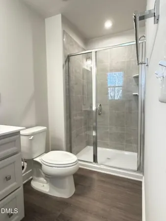 a bathroom with a toilet and a shower