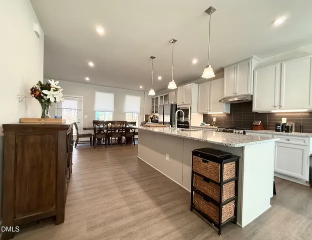 a open kitchen with stainless steel appliances granite countertop a stove refrigerator and cabinets