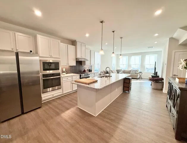 a large kitchen with stainless steel appliances