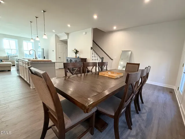 a dining room with furniture and wooden floor