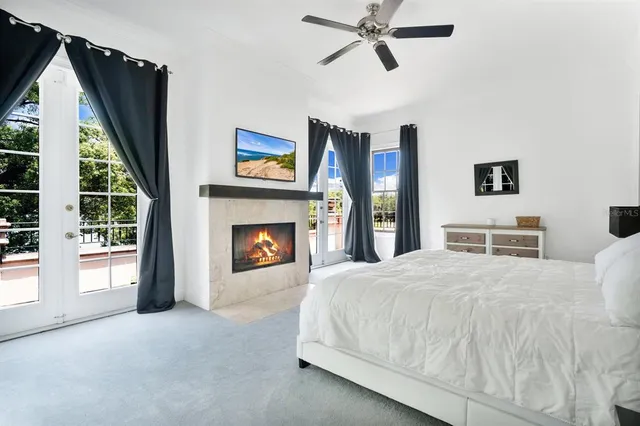 a spacious bedroom with a bed and a fireplace