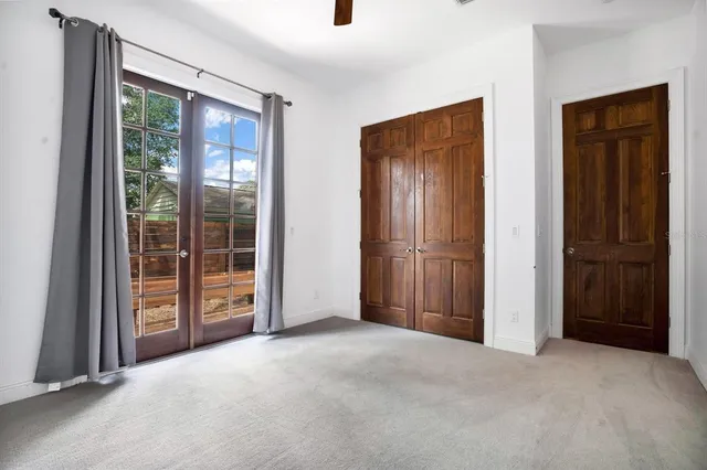 an empty room with windows and closet