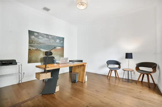 a dining room with furniture and wooden floor