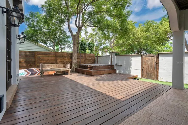 a view of a balcony with furniture and wooden floor