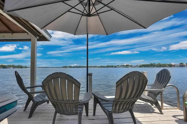a view of a roof deck with couches and wooden floor