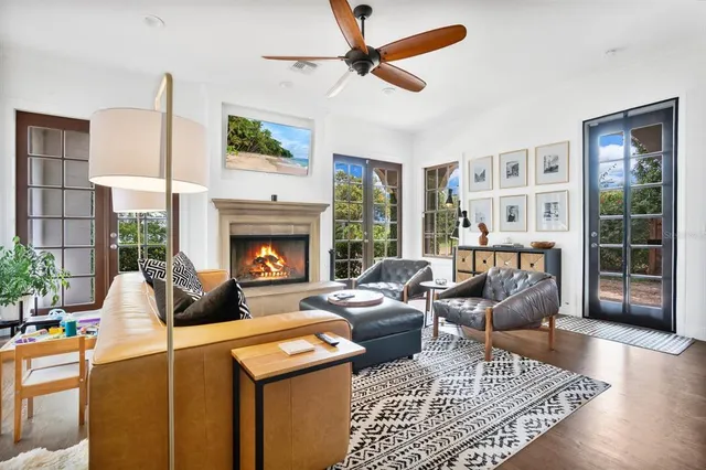 a living room with furniture a rug and a fireplace