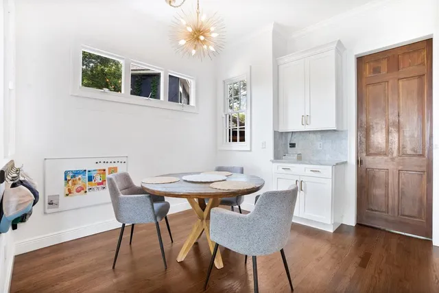 a view of a dining room with furniture and wooden floor