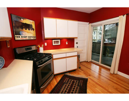 38 Maple Avenue, Unit 1 Cambridge, MA 02139 - Photo 4 of 10 a kitchen with stainless steel appliances granite countertop a stove a sink and a microwave