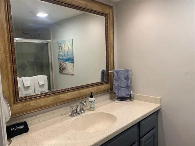 a bedroom with bed and a night stand