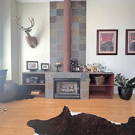 a living room with furniture a chandelier and a fireplace