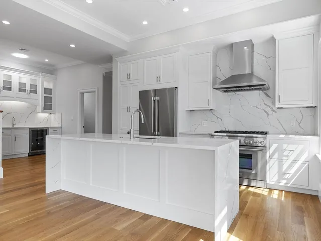 a kitchen with stainless steel appliances granite countertop a stove and a refrigerator