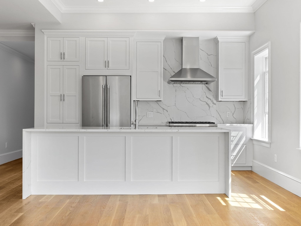 944 East Broadway, Unit 3 Boston, MA 02127 - Photo 3 of 33 a kitchen with stainless steel appliances white cabinets and a refrigerator