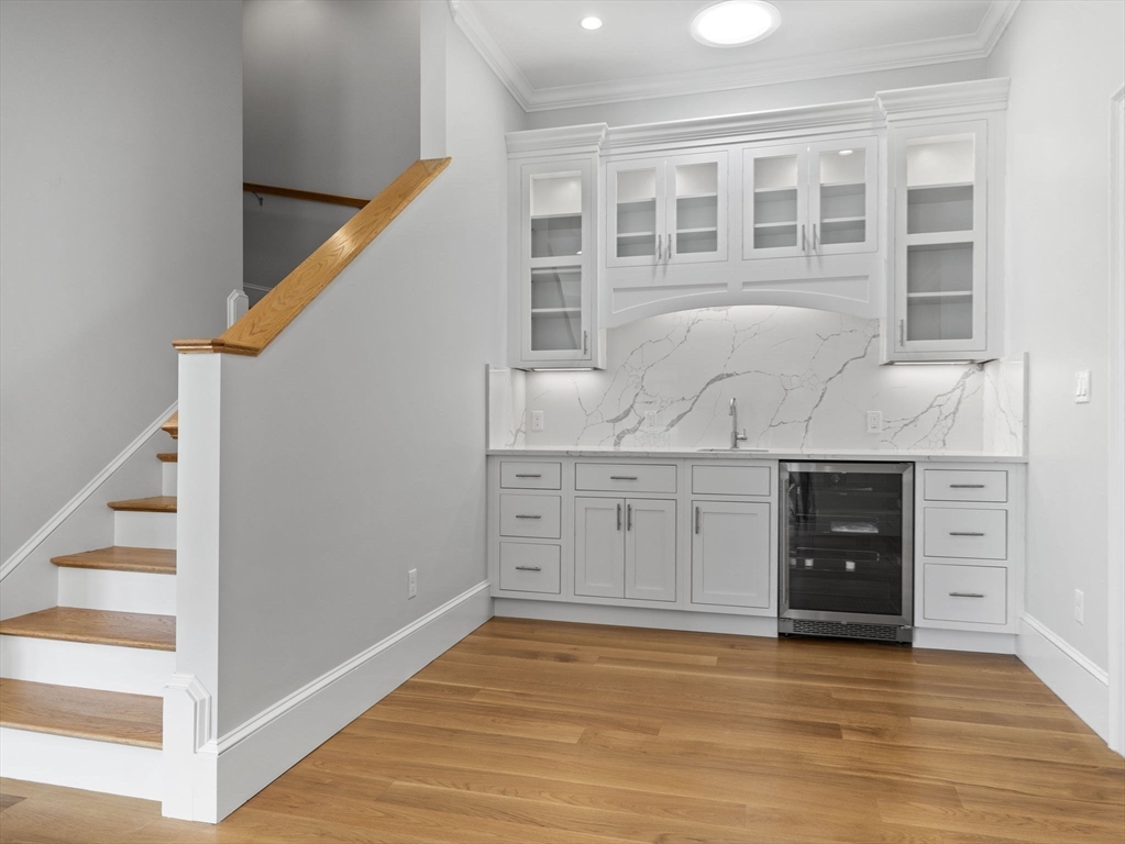 944 East Broadway, Unit 3 Boston, MA 02127 - Photo 8 of 33 a view of an empty room with wooden floor and cabinet