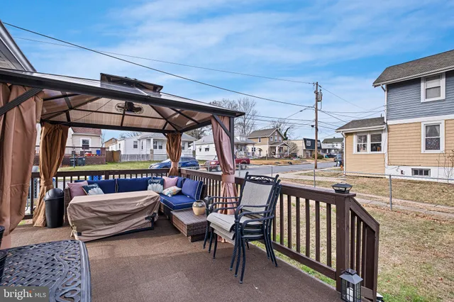 a backyard of a house with barbeque oven table and chairs