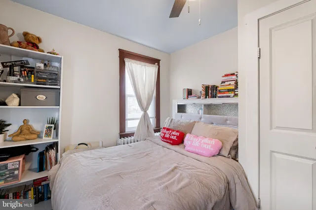 a bedroom with a bed and a window