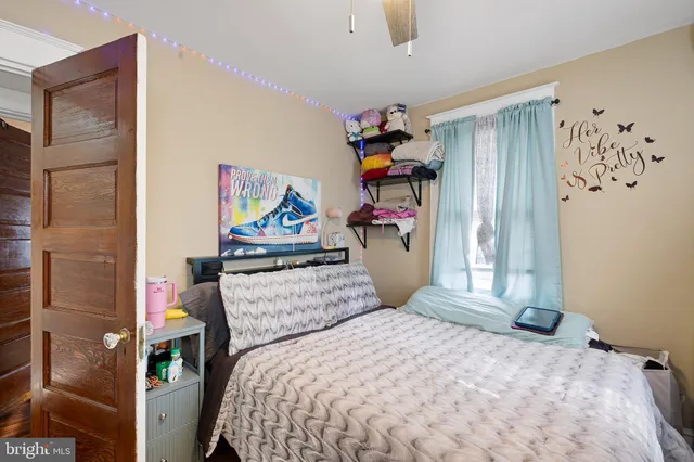 a bedroom with a bed and a flat tv screen in it