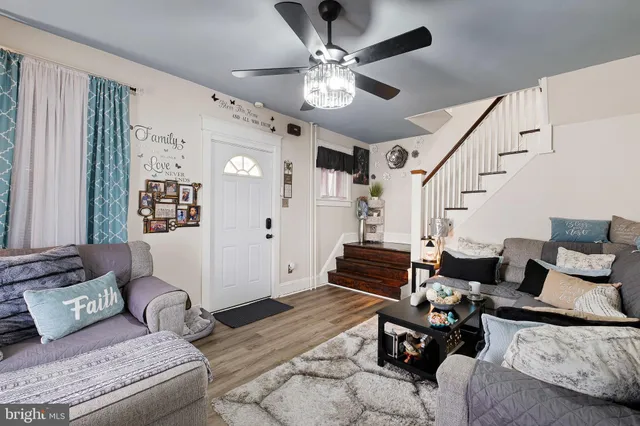 a living room with furniture and wooden floor