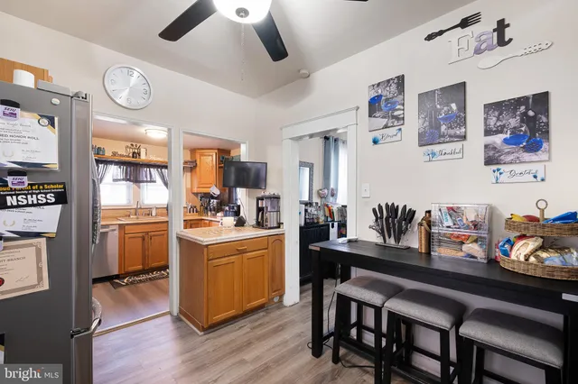 a kitchen with granite countertop stainless steel appliances a table and chairs