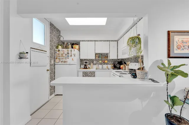 a view of living room with furniture and a potted plant