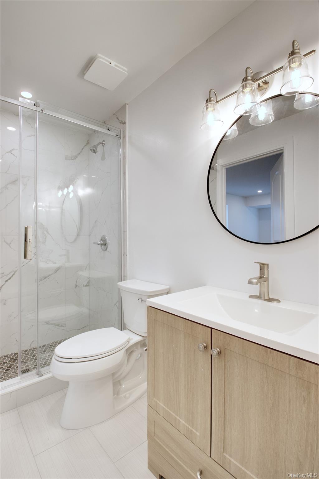 30 Kirkwood Road, Unit B Port Washington, NY 11050 - Photo 33 of 36 a bathroom with a sink toilet and shower
