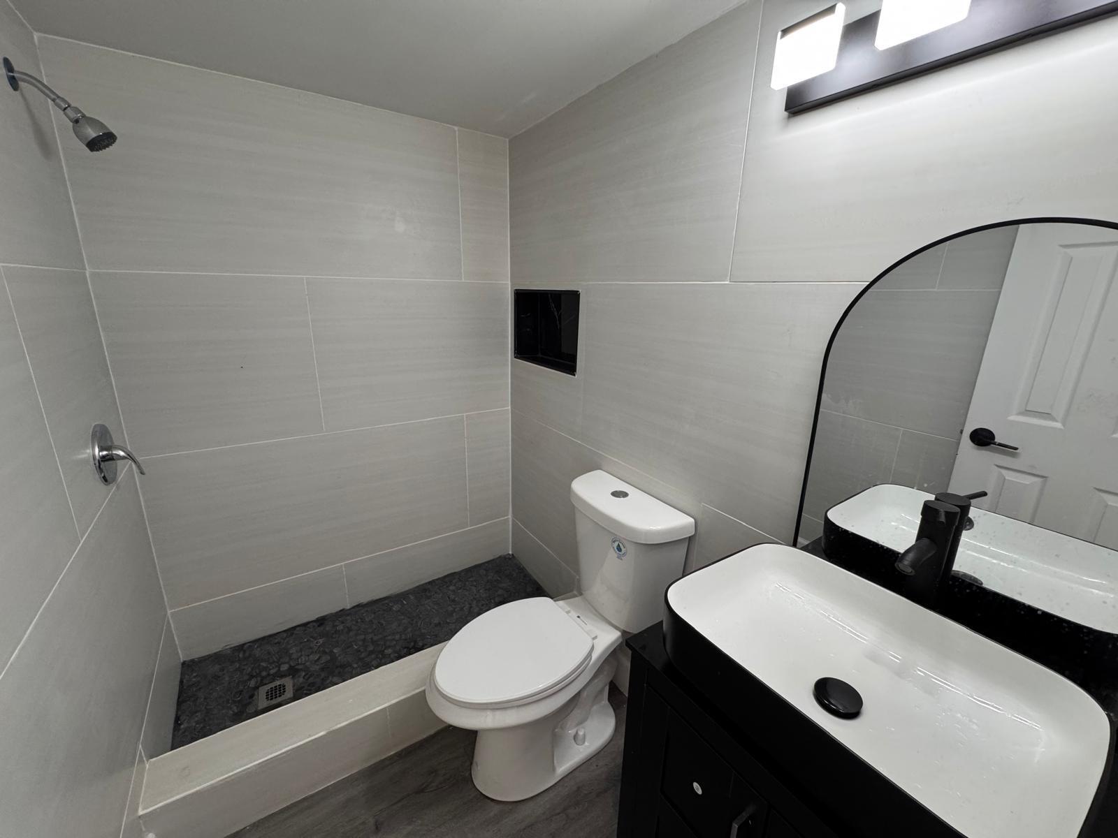 357 Hunting Club Avenue Clewiston, FL 33440 - Photo 11 of 37 a bathroom with a toilet a sink and shower