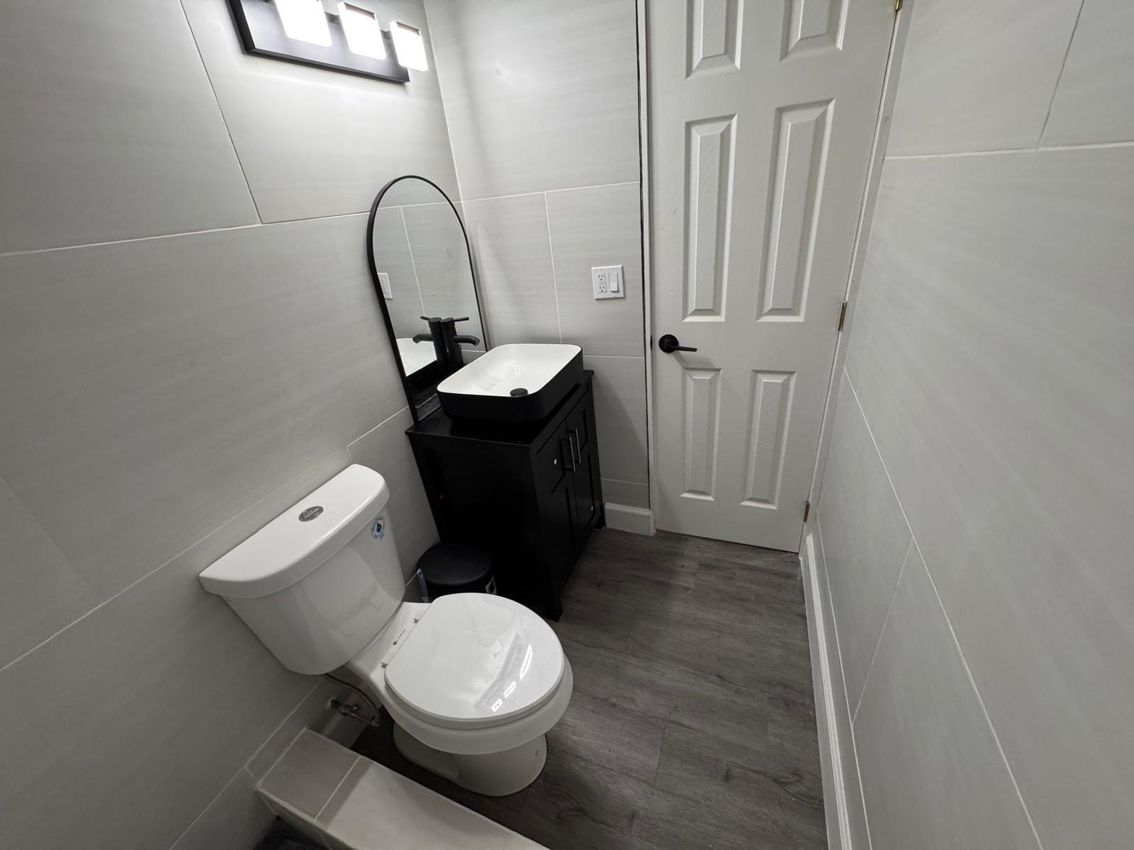 357 Hunting Club Avenue Clewiston, FL 33440 - Photo 13 of 37 a toilet sitting in a bathroom next to a sink