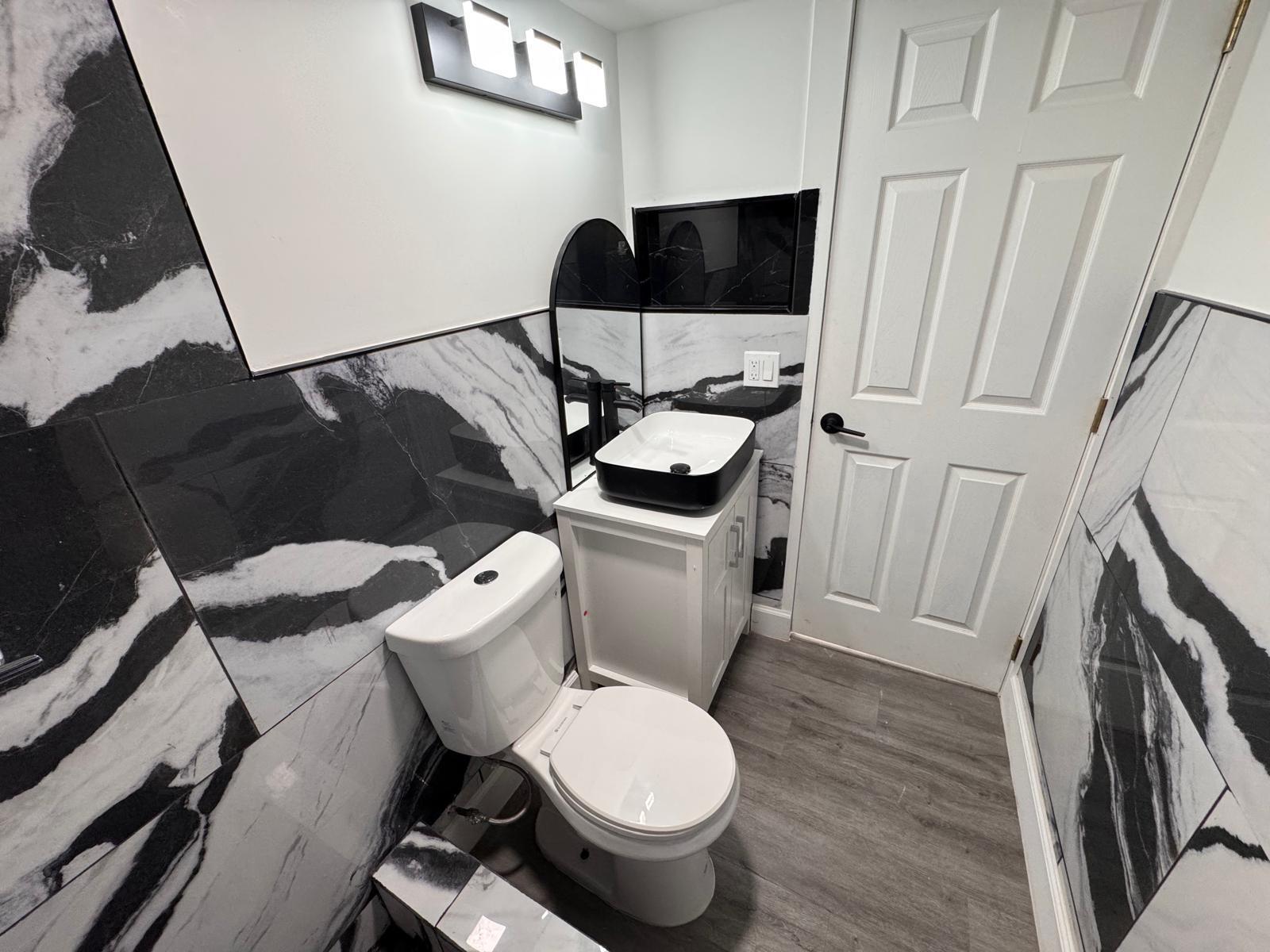 357 Hunting Club Avenue Clewiston, FL 33440 - Photo 17 of 37 a white toilet sitting next to a small bathroom