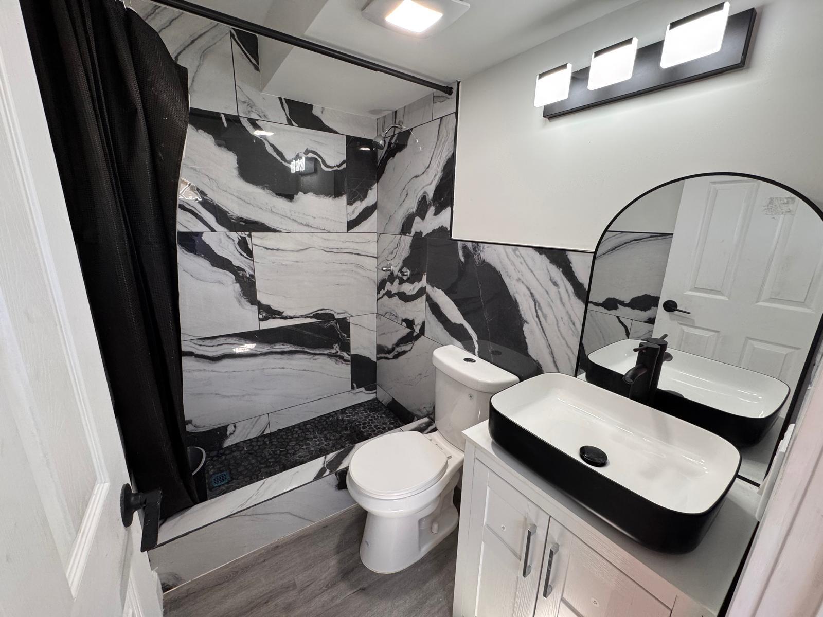 357 Hunting Club Avenue Clewiston, FL 33440 - Photo 18 of 37 a bathroom with a toilet a sink and mirror