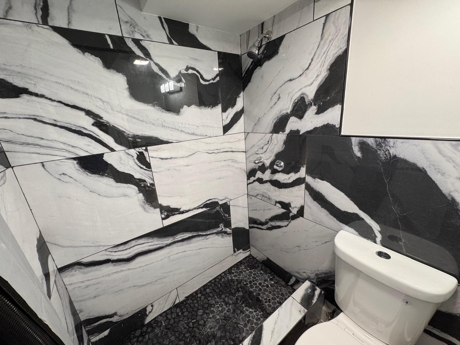 357 Hunting Club Avenue Clewiston, FL 33440 - Photo 19 of 37 a bathroom with a toilet and a shower