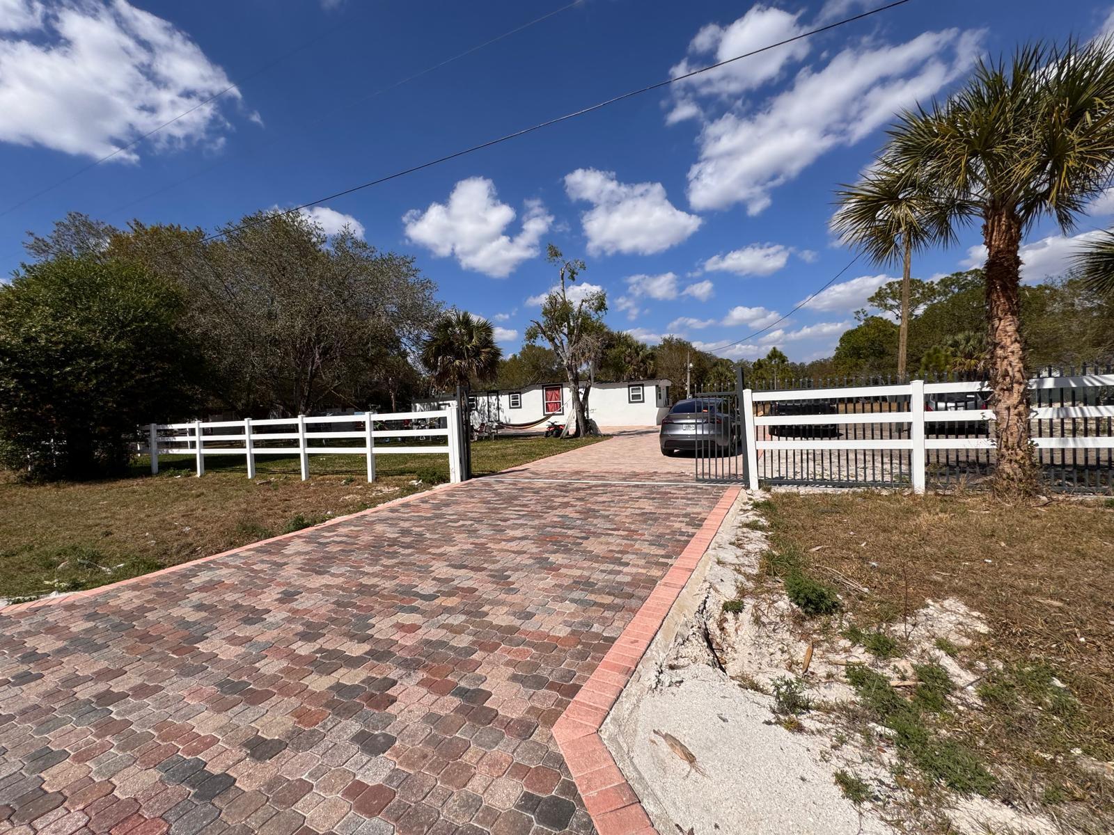 357 Hunting Club Avenue Clewiston, FL 33440 - Photo 2 of 37 a view of a backyard with a garden