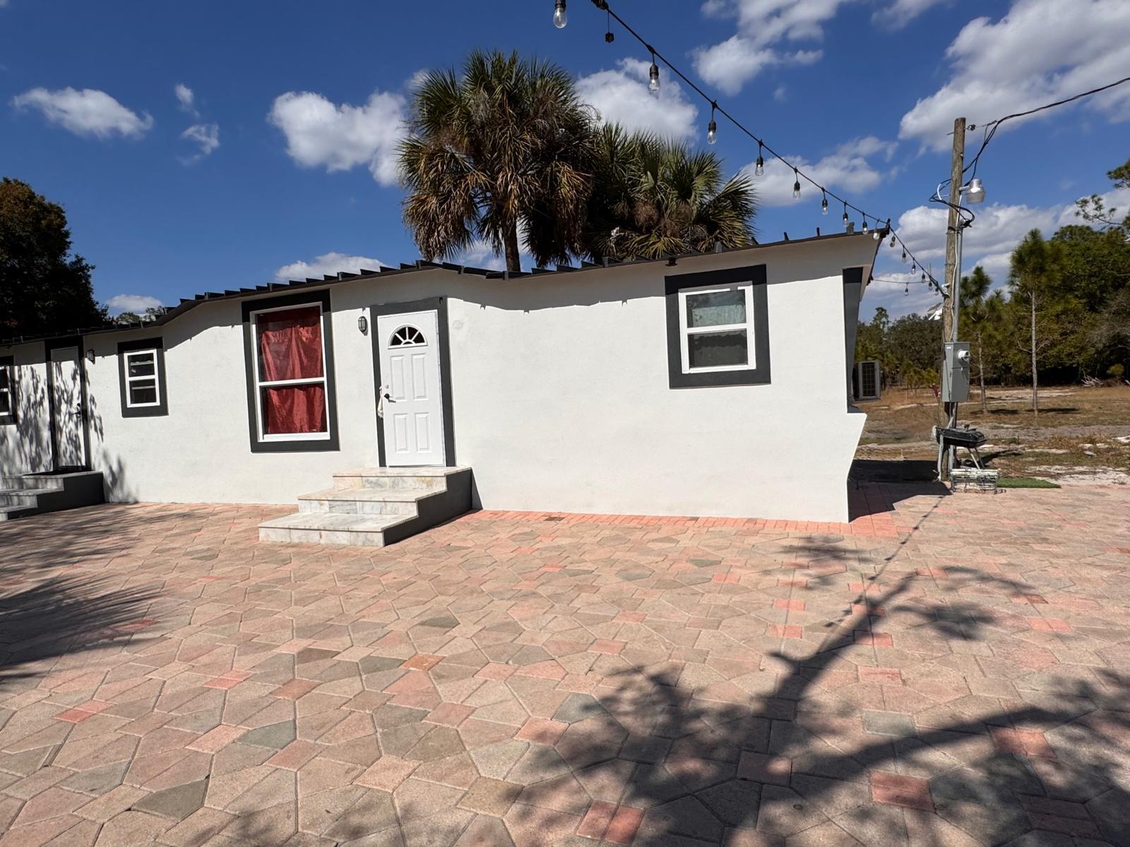 357 Hunting Club Avenue Clewiston, FL 33440 - Photo 27 of 37 a front view of a house with a yard