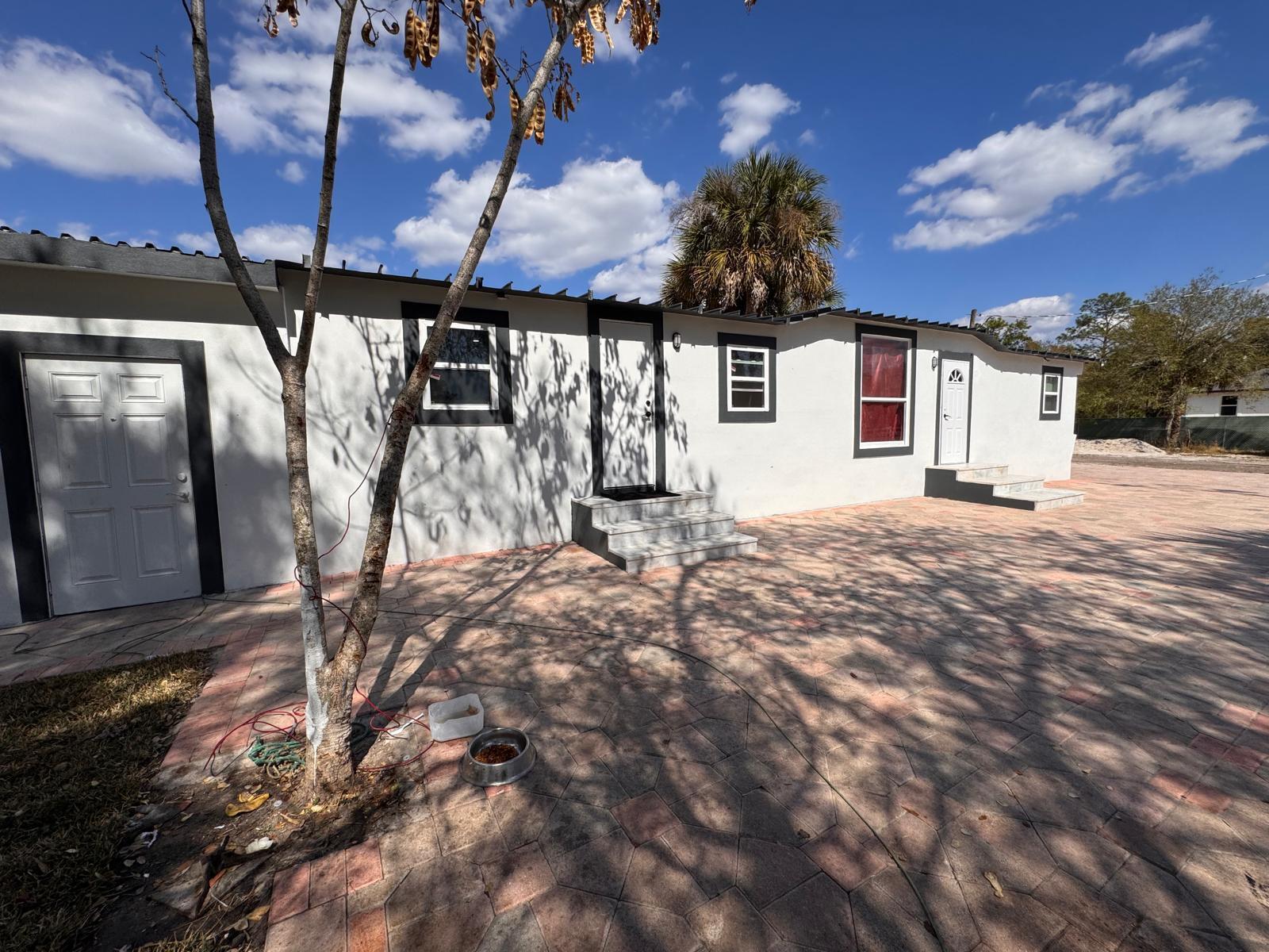 357 Hunting Club Avenue Clewiston, FL 33440 - Photo 28 of 37 a backyard of a house with table and chairs