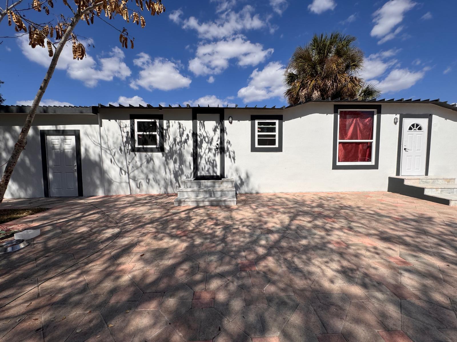 357 Hunting Club Avenue Clewiston, FL 33440 - Photo 29 of 37 a front view of a house with a yard