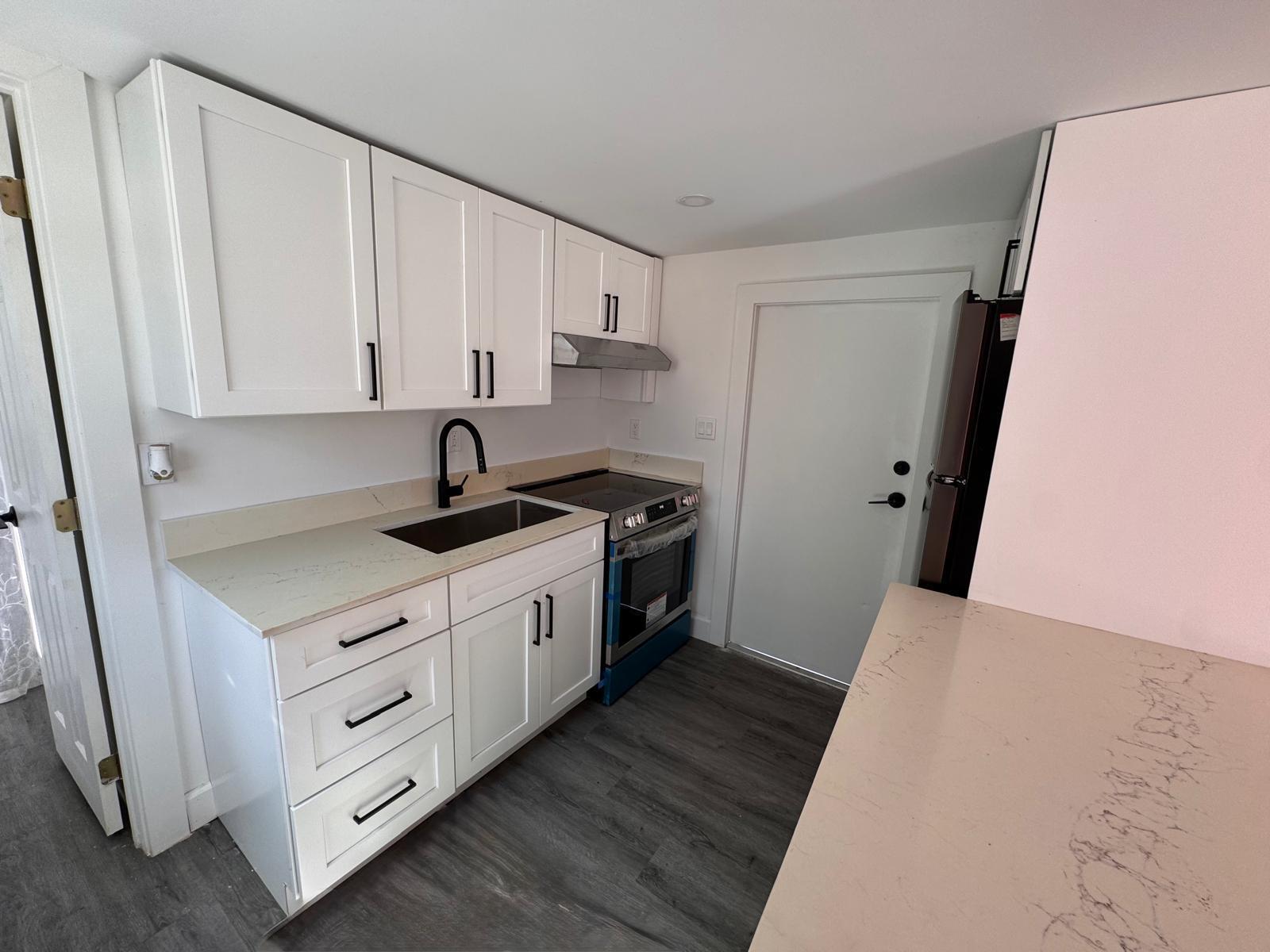 357 Hunting Club Avenue Clewiston, FL 33440 - Photo 3 of 37 a kitchen with white cabinets and sink