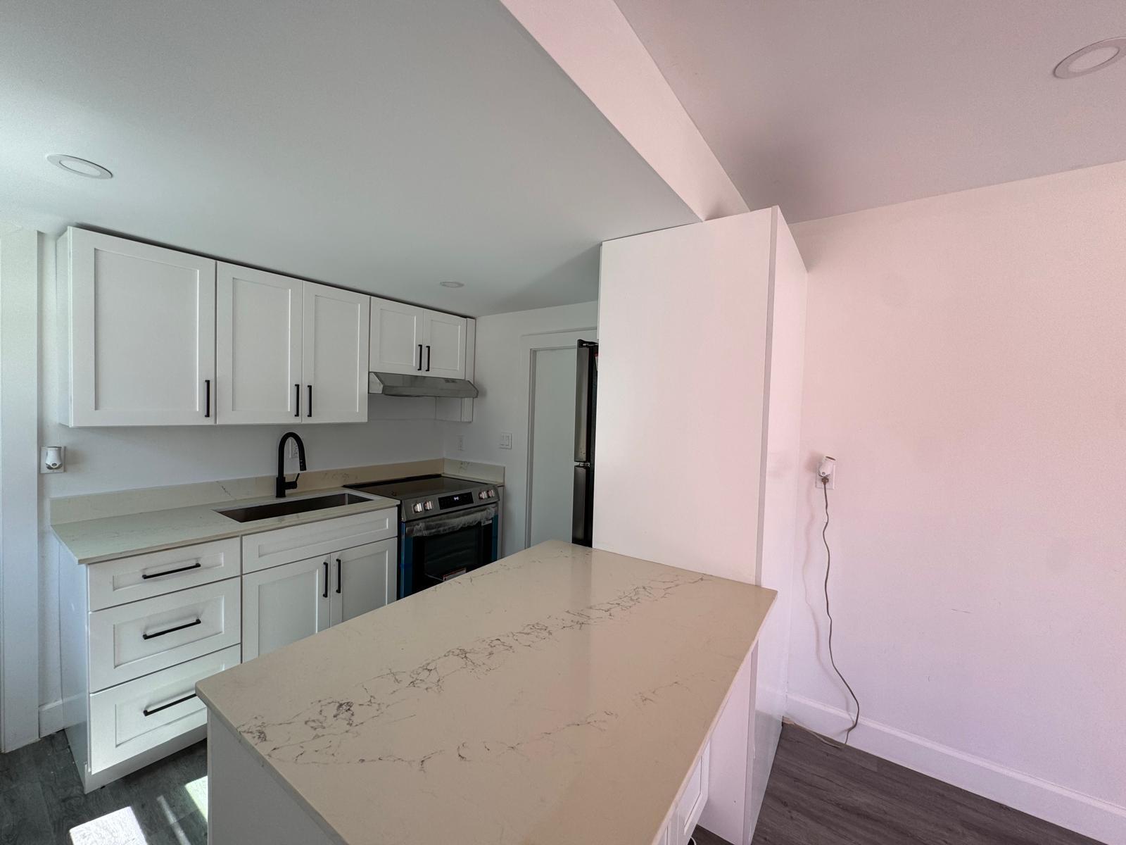 357 Hunting Club Avenue Clewiston, FL 33440 - Photo 4 of 37 a kitchen with a sink a stove and cabinets