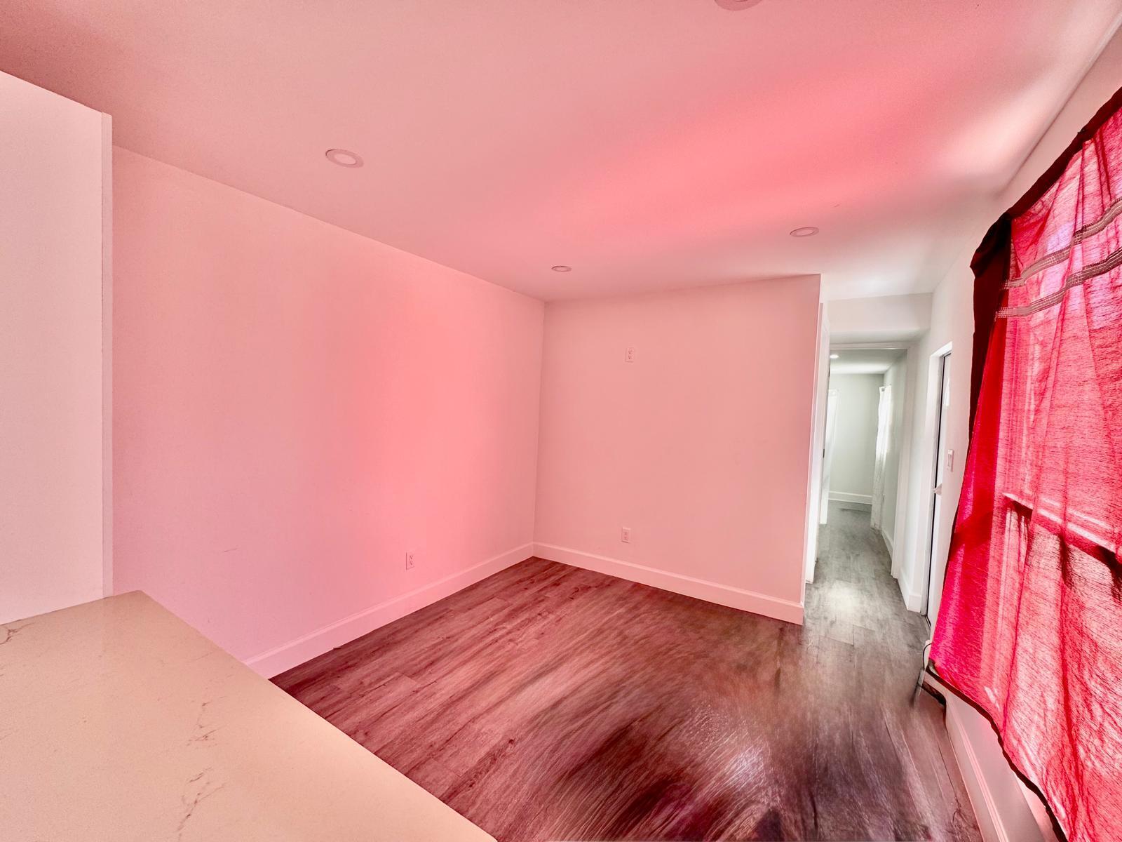357 Hunting Club Avenue Clewiston, FL 33440 - Photo 8 of 37 a view of a room with wooden floor and a window