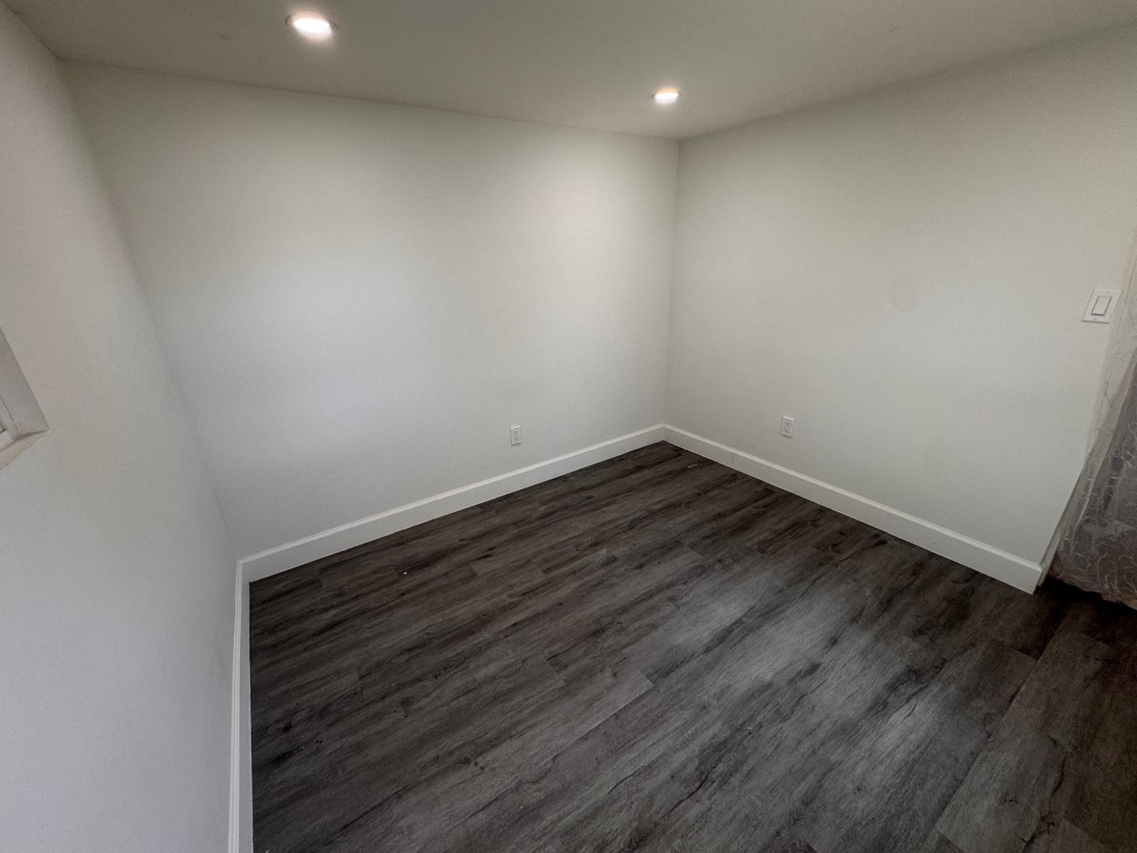 357 Hunting Club Avenue Clewiston, FL 33440 - Photo 10 of 37 a view of room with wooden floor and fan